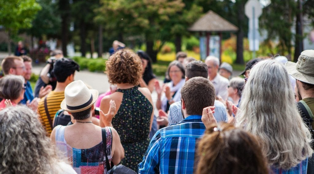 A diverse Australian community gathered together in the street